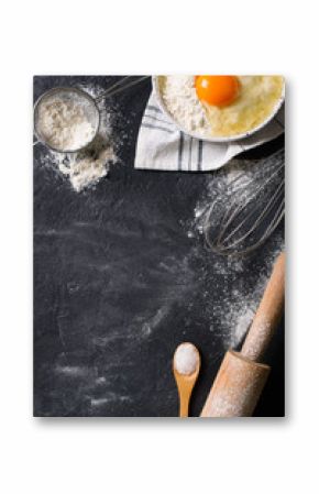 Cooking and baking utensils on black texture, vertical