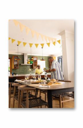 Senior couple preparing festive meal in modern kitchen, enjoying togetherness