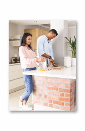 Couple preparing breakfast together in modern kitchen, enjoying morning routine