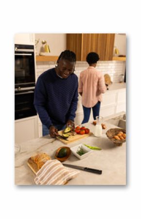 At home, preparing food in modern kitchen, african american couple smiling and enjoying time