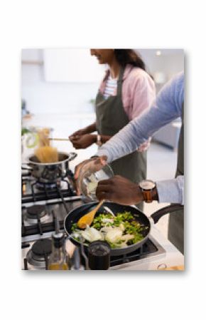 Cooking together, couple preparing meal with fresh vegetables in modern kitchen