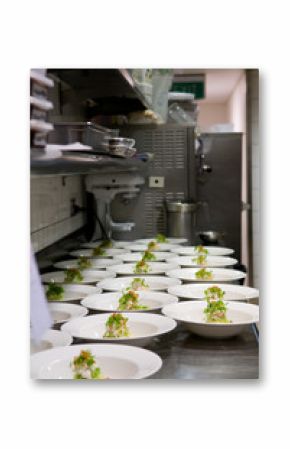 Neat rows of prepared food in a busy restaurant kitchen