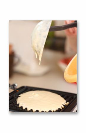 Waffle iron preparing waffles in kitchen