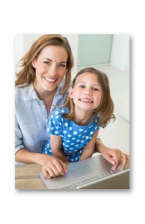 Happy girl with mother using laptop