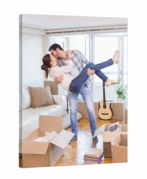 Cute couple unpacking cardboard boxes