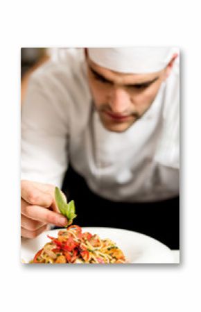 Chef garnishing pasta