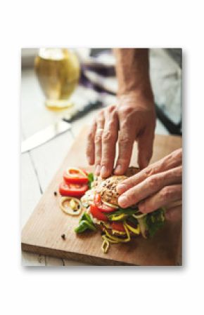 Man preparing big sandwich