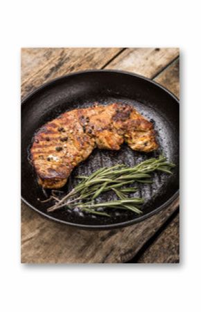Roasted beefsteak with bunch of rosemary on grill pan