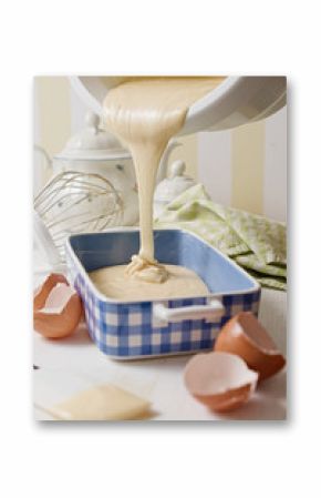 Homemade yogurt sponge cake batter poured in blue ceramic dish