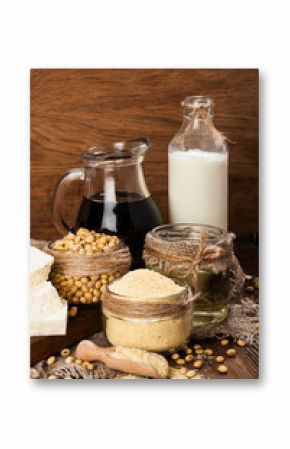 Soy products (soy flour, tofu, soy milk, soy sauce) on a wooden background. rustic style