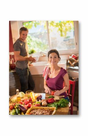 Nice couple cooking together a vegetable meal in the kitchen