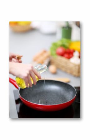 Human hands with oil and frying pan on stove, closeup