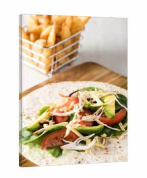 shredded barbecued chicken wraps with carrot, cheese, avocado an