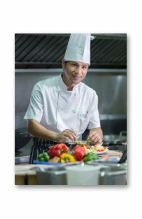 Portrait of a smiling male chef with cooked food standing in the kitchen, Chef Thailand