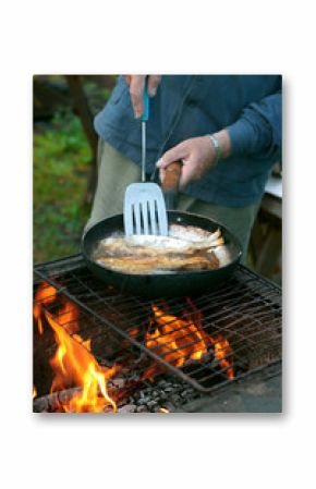 fish frying in oil on the fire