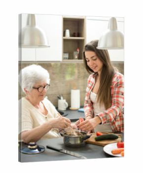 Grandmother and granddaughter cooking in the kitchen.
