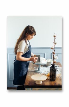 Chef decorating a delicious cake with cream