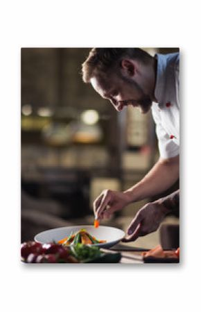 male cooks preparing meals in restaurant kitchen