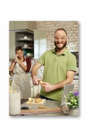 Funny man peeling onion in protective eyewear