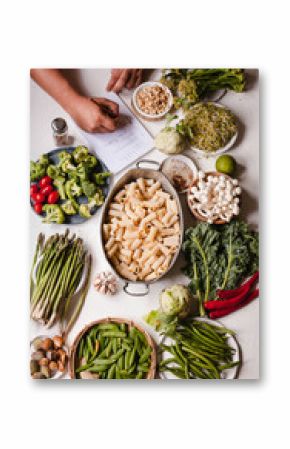 Pasta rigatoni casserole Nourishment cooking ingredients list write person hand vegan food 