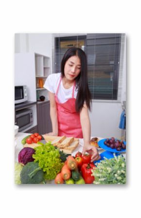 woman holding tomato in kitchen room