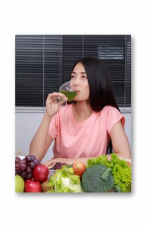 woman drinking vegetable juice in kitchen