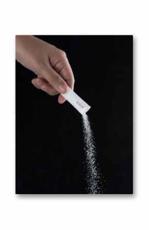 Pouring sugar bag on a black background