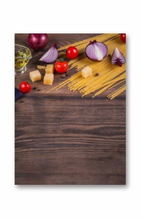 Ingredients for cooking spaghetti - raw pasta, tomato, olive oil, spices, herbs