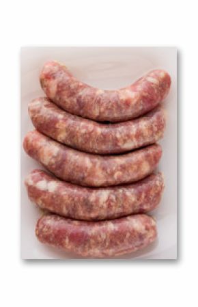 Raw sausages for a barbecue on a white plate. Several barbecue sausages lie next to each other.