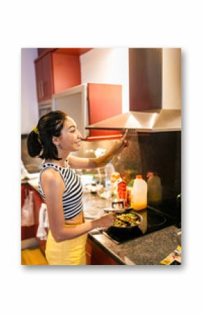 Woman cooking on modern induction cooker stove in the kitchen