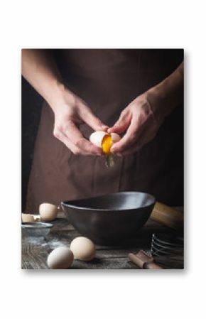 hands are breaking an egg