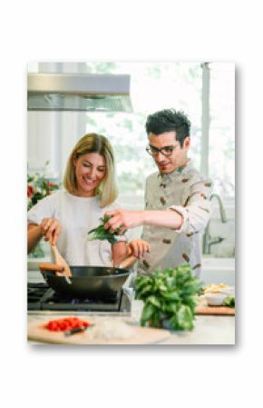 Happy couple cooking in the kitchen