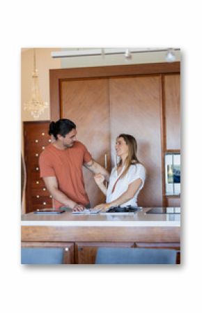 Preparing meal, couple laughing together in modern kitchen, sharing joyful moment