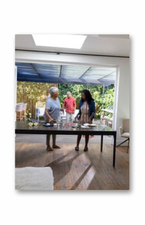 African American family enjoying conversation while preparing food together at home