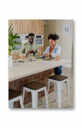 Couple preparing meal together in modern kitchen, enjoying quality time cooking