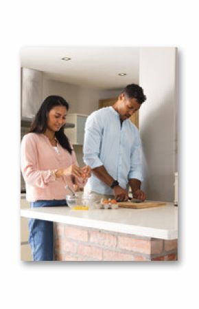 Couple preparing breakfast together in modern kitchen, enjoying morning routine