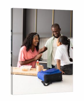 African American family in kitchen, smiling and preparing lunch together at home