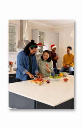 Christmas time, multiracial friends preparing holiday meal together in kitchen, at home