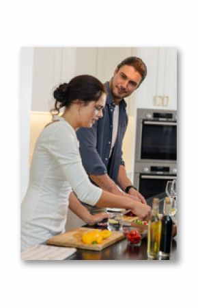 Couple preparing meal together in kitchen, enjoying cooking and conversation, at home