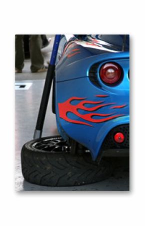 changing a race cars tires with flame decals