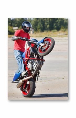 Stunt rider making wheelie