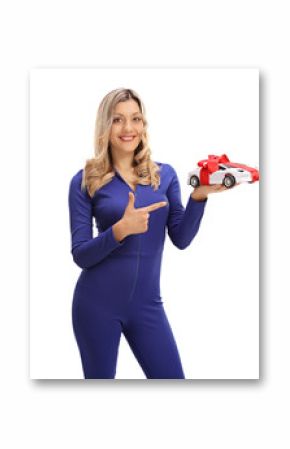 Cheerful female car racer holding a model car and pointing