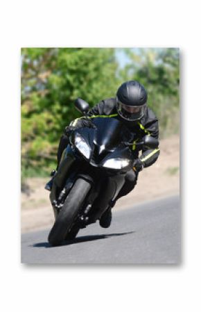 The biker on the black sports motorcycle in turn on speed