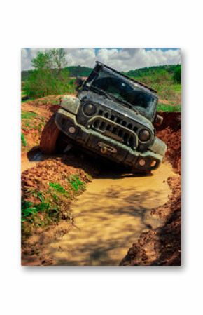 All-terrain vehicle crossing an area of mud with great lateral slope