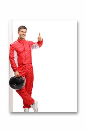 Racer leaning against a wall and holding his thumb up