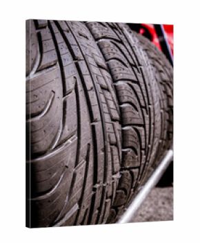 Wet tread car tire set aligned in a row