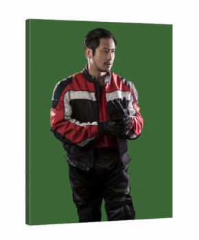 Male wearing protective leather and textile suit for racing race cars or motorcycles.  The armor is worn in professional motor sports.  The man is on a green screen or chroma key background.