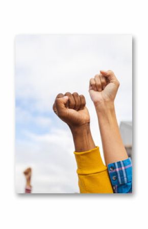 Diverse people raising their fists at a protest march