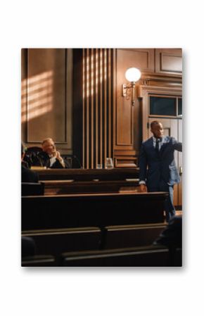 Court of Justice and Law Trial: Male Public Defender Presenting Case, Making Passionate Speech to Judge, Jury. African American Attorney Lawyer Protecting Client's Innocents with Supporting Argument.