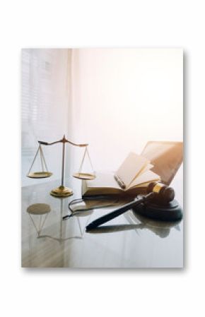 law books and scales of justice on desk in library of law firm. jurisprudence legal education concept.